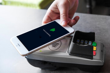 Woman paying with her smartphone.