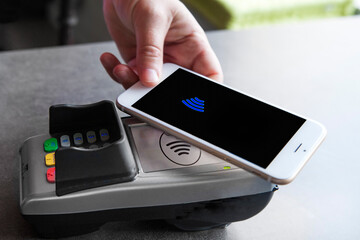 Woman paying with her smartphone.