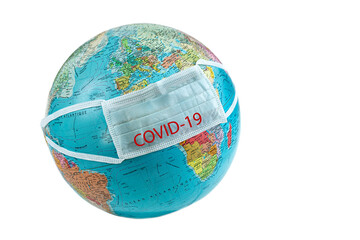 Medical mask placed on the globe to show the pandemic covid 19.