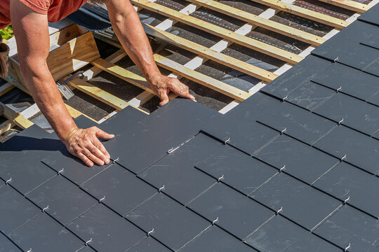 Close-up of the gesture of the hands of the roofer.