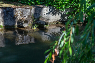Discharge of polluted water into the river. Nature in danger.