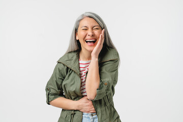 Funny situation. Laughing extremely amused mature middle-aged woman in casual clothes laughing of a good joke, humor, anecdote isolated in white background
