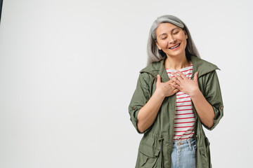 Pleased touched with a compliment caucasian mature middle-aged woman in casual clothes listening to praise isolated in white background - obrazy, fototapety, plakaty