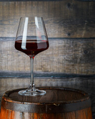 Glass of red wine on wooden background, copy space