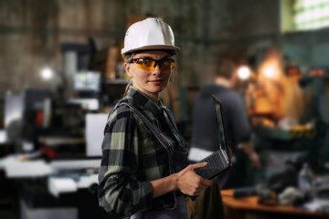 Portrait of a female engineer working in a production shop