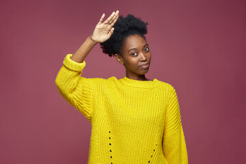 Confident stylish young african american woman with afro hair saluting, showing respect, doing honour gesture - obrazy, fototapety, plakaty