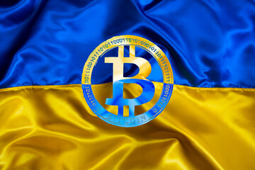 Bitcoin sign on Ukrainian national flag background