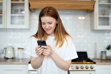 Uses a phone app and an internet site. Young female freelancer online learning education at home.