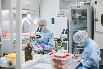 Women work in the lab. Conducts experiments on vaccines.