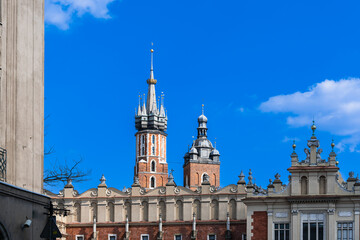 Fototapeta na wymiar Main market and towers of St. Mary's Basilica, historic center of Old Krakow on a sunny day, Poland