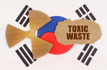 On the flag of South Korea, the symbol of radioactivity and torn cardboard with the inscription - Toxic waste