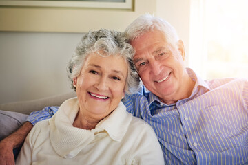 Love is what holds us together. Portrait of a senior couple relaxing at home.