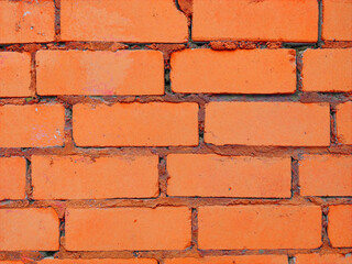 Brick wall. Background. Abstraction. Construction. The brick wall is orange.