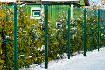 fence grid, pictured is a green fence grid on a garden plot