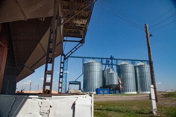Modern grain storage elevator and vintage wooden electric pole (right).
