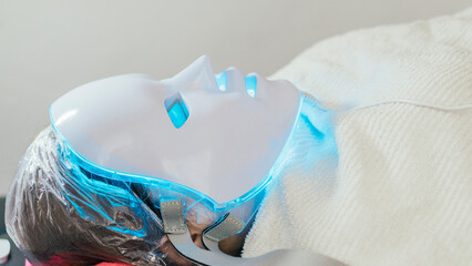 Unrecognizable person with mask for dermatological treatment. 