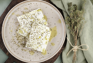 Fresh feta cheese with oregano and olive oil on plate