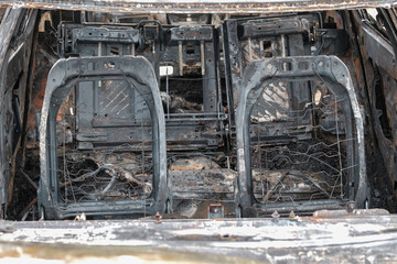 Burnt car with small flames inside of the engine. Burnt new car. malfunction that led to the death...