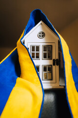 Ukrainian house, city with national yellow-blue flag. Shelter for homeless refugees from Ukraine to...