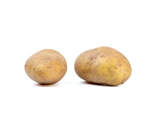 Tubers of unpeeled raw potatoes on a white background.