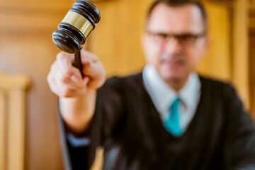 portrait judge man in courtroom  holding judge gavel 