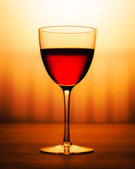wine glass on a porch looking out into a sunset