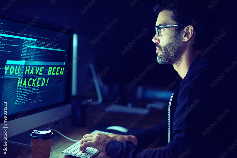 Aufkleber He could be coming for you. Shot of a focussed computer hacker using a computer in the dark.