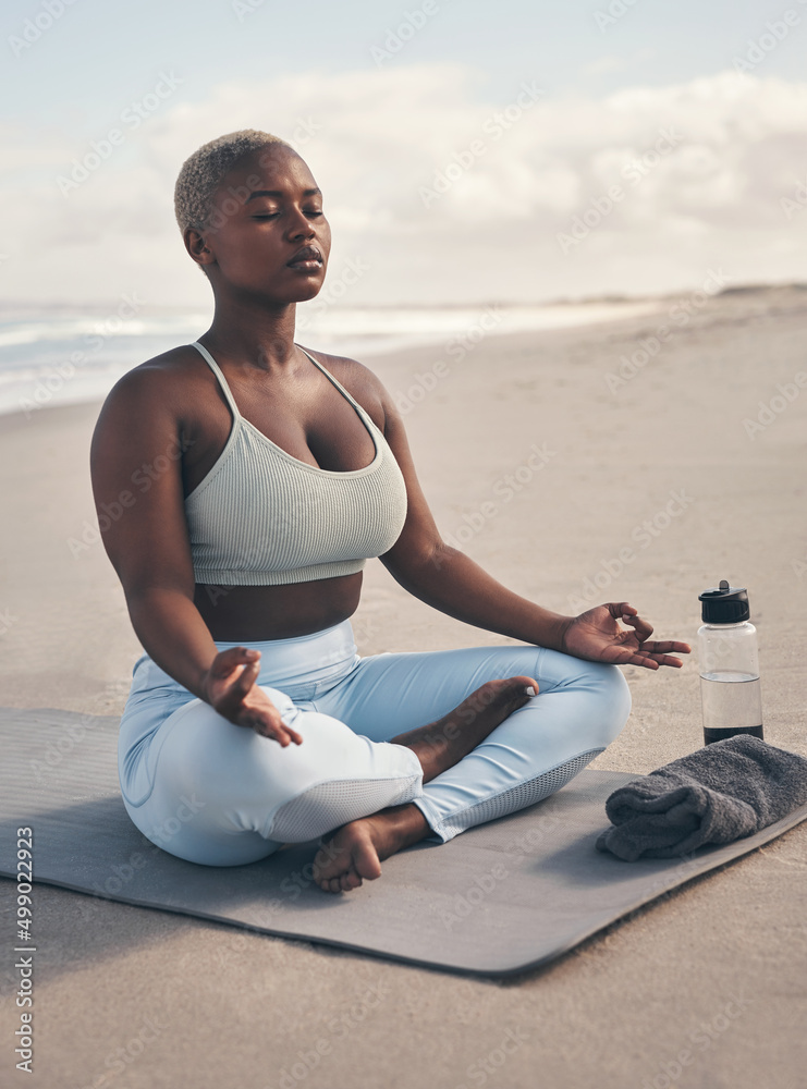 Sticker yoga helped me to find a home within myself. shot of a woman meditating during her yoga routine on t