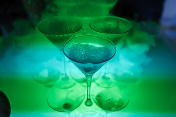 Glasses of champagne with dry ice. Champagne slide. Pyramid or fountain made of champagne glasses