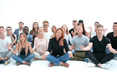 group of concentrated young people sitting on the floor.
