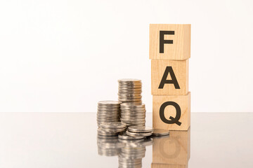 FAQ - Frequency Asked Questions - acronym on wooden cubes on white background with coins