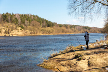 A fisherman fishing with a rod