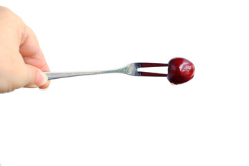 ripe cherries, sweet cherries are pricked on a fork, concept photography on the background, vegetarian food, wholesome healthy eating, food enriched with vitamins