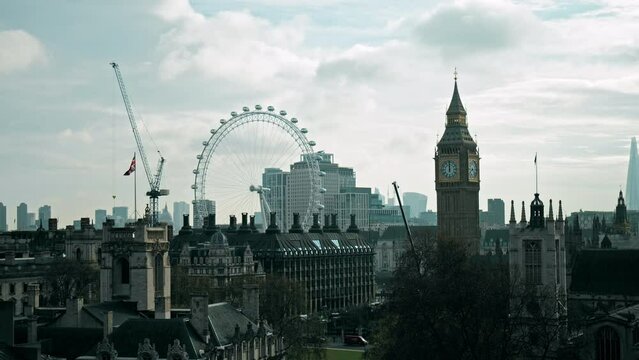Aerial Timelapse view of the Big Ben, Parliament Square with busy London traffic. Scenic panoramic view of the city of Westminster with many tourists on a sunny day.