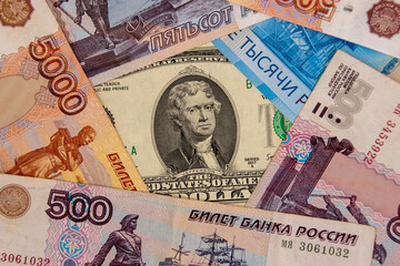 Two dollar banknote surrounded by ruble banknotes