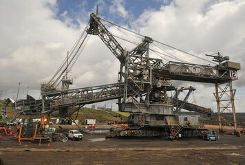 Fototapeta na wymiar Dredge maintenance-replacing bucket wheel on site Yallourn opencut coal mine, in Gippsland Victoria. The brown coal is mined by several dredges working around the perimeter of the open cut.