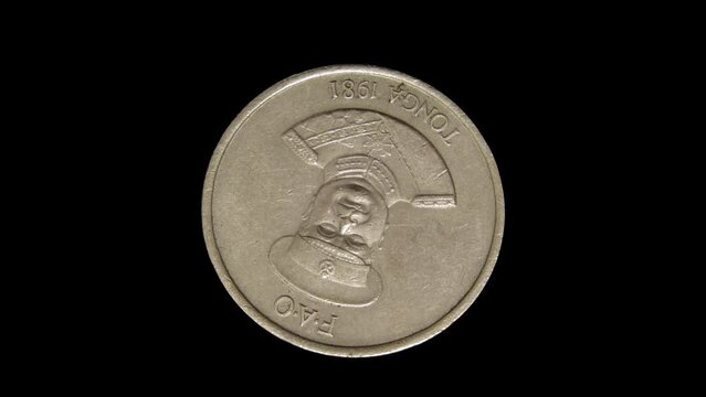 Rotating obverse of Tonga coin 10 seniti 1981. Isolated on black background.