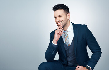 The path to greatness consists of having a strong purpose. Studio shot of a handsome young businessman looking thoughtful against a grey background.