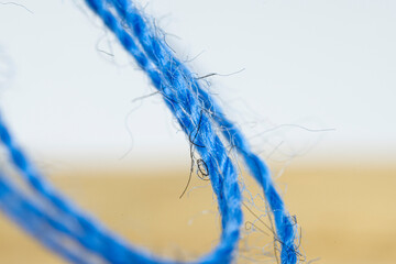 Blue thread for sewing with a needle. Close-up, macro photography. Fibers of threads.