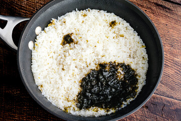 Sushi Rice that has Been Cooked with a Nori Sheet: Fresh sushi rice in a saucepan that has been cooked with a piece of seaweed