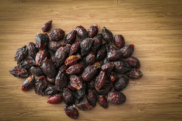 Rosehips on a wooden bakcground.