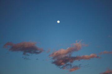 Fototapeta na wymiar full moon and clouds at sunset