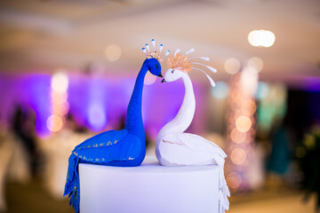 Beautiful Indian wedding cake in a shape of blue and white peacocks close up