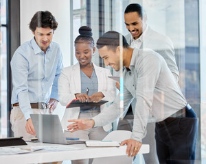 A tech-focused team. Shot of a group of businesspeople brainstorming and exchanging ideas in a modern office.