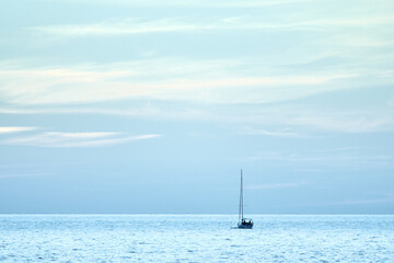 Fototapeta na wymiar Sailing boat at sea. Sailboat management. Evening sea landscape.