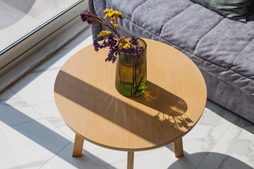 Dry decorative flowers in the vase in a natural sunlight