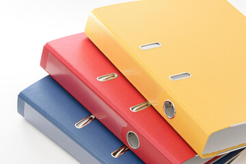 Yellow, red and blue empty office folder on white background.