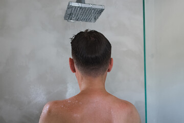 Young man taking shower in the morning.