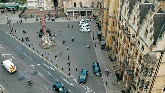 Aerial top view of many tourists in front of Westminster Abbey, London. Scenic view from the top of busy London at famous tourist attractions.
Aerial top view of many tourists in front of Westminster 