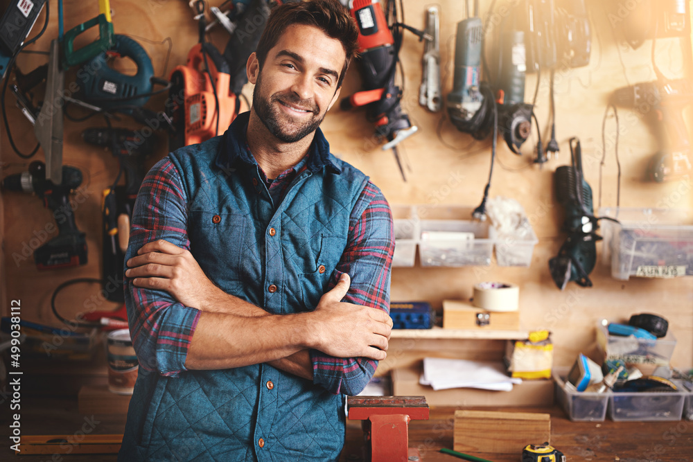 Sticker All the toys a man could ask for. Portrait of a man standing in his workshop.